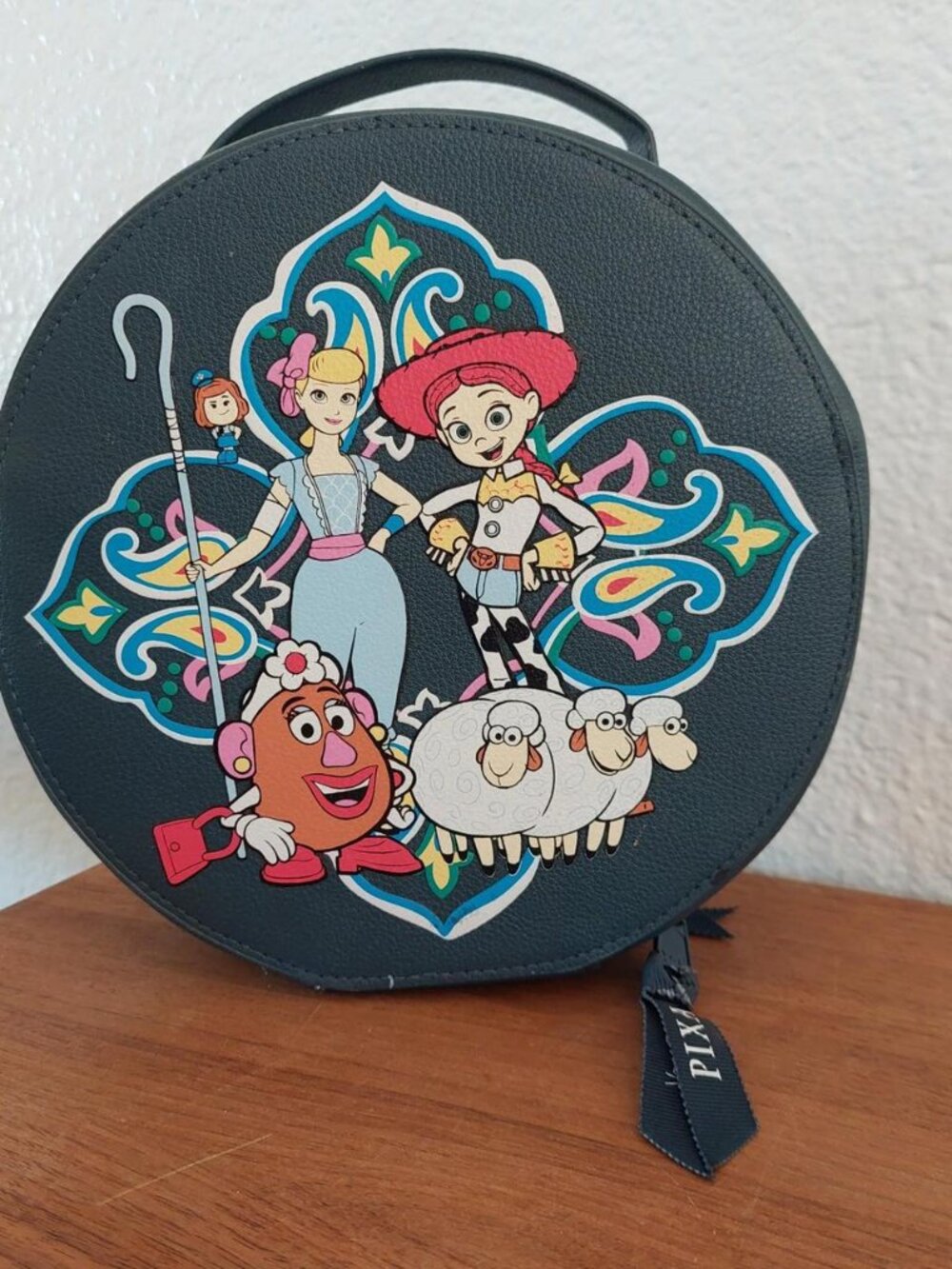 round Vera Bradley Disney Pixar Whimsy Cosmetic Case in the Andy's Room pattern